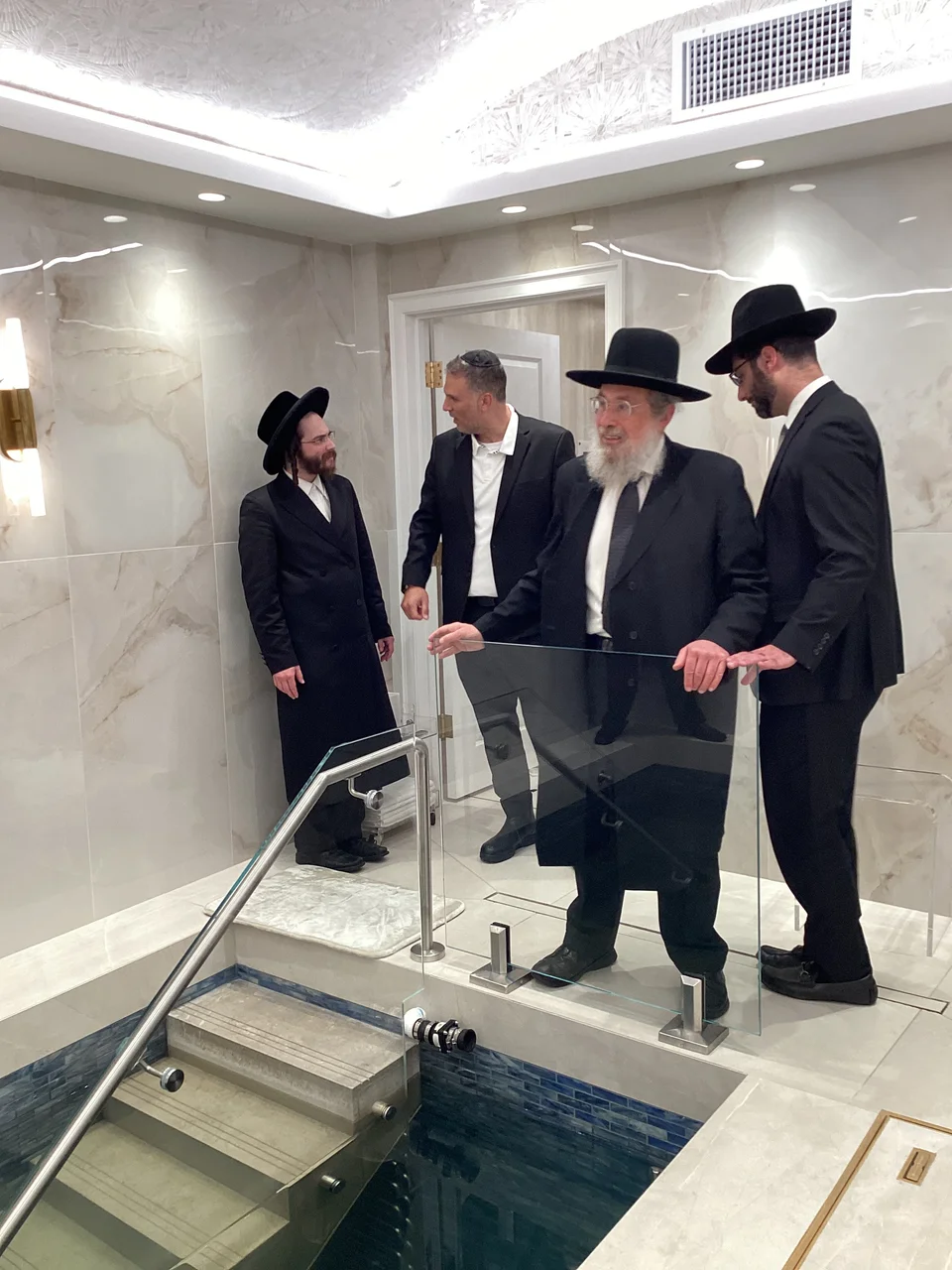Rabbi gantzvi and his beth din ispecting the mikvah