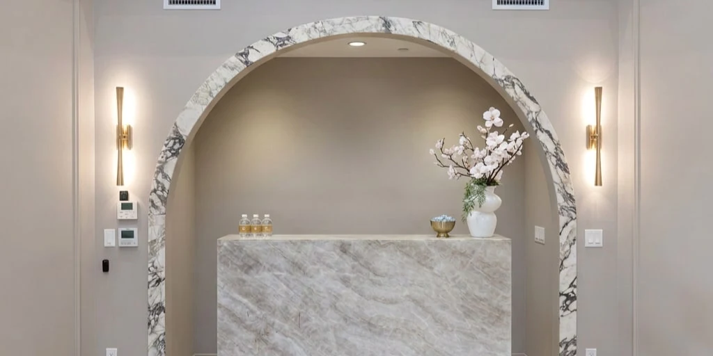 The reception desk, set beneath a marble arch