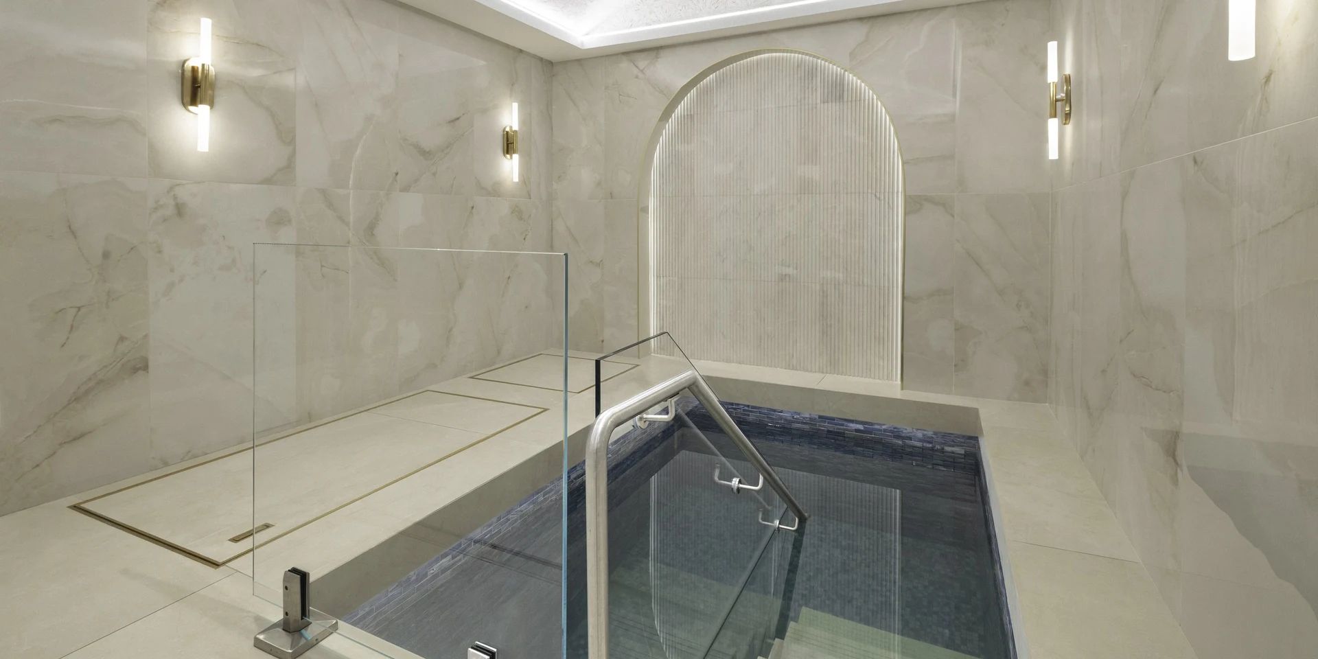 The mikvah pool, in pale stone beneath an arched alcove