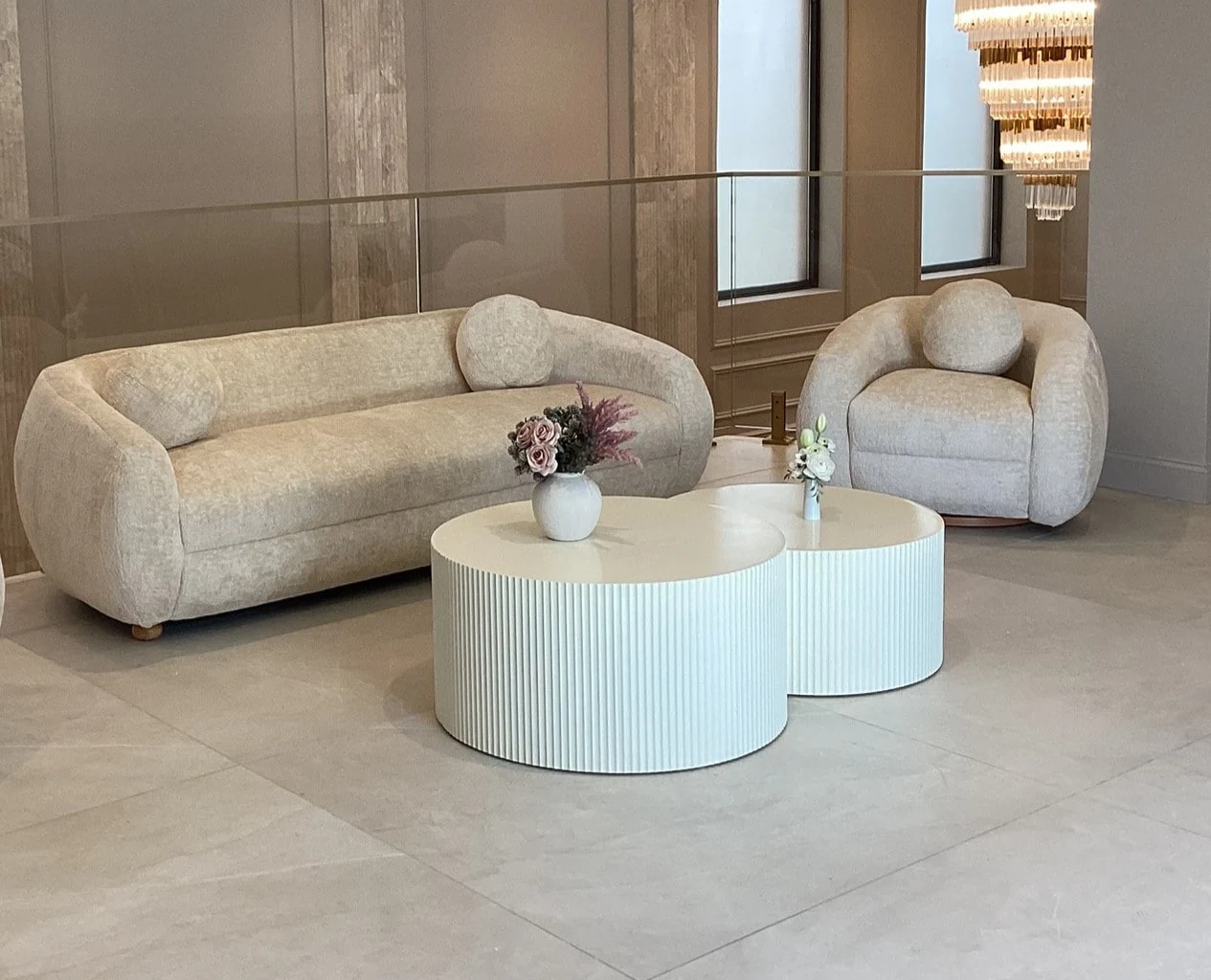 The lounge where tours begin, in boucle and travertine